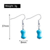Turquoise earrings with measurements on a white background