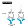 Pair of earrings with blue beads and silver hooks, shown with measurements and weight on a white background.