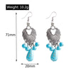 Pair of silver earrings with blue beads, shown with measurements on a white background.