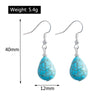 Turquoise teardrop earrings with measurements and weight on a white background