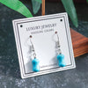 Turquoise earrings on a 'Luxury Jewelry' card with a dark background