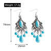 Pair of earrings with blue stones and silver accents, shown with measurements and weight on a white background.