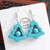 Turquoise triangle-shaped earrings on a white card with 'Handmade' text.