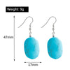 Turquoise earrings with measurements and weight on a white background