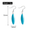 Turquoise earrings with measurements and weight on a white background