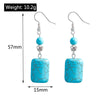 Turquoise earrings with measurements and weight displayed on a white background