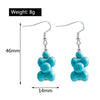 Turquoise stone earrings with measurements on a white background