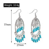 Pair of silver earrings with turquoise beads, showing weight and dimensions on a white background.