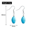 Turquoise stone earrings with measurements on a white background