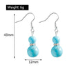 Turquoise beaded earrings with measurements and weight displayed on a white background