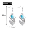 Pair of earrings with blue gemstones and silver designs, shown with measurements and weight on a white background.