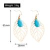 Gold leaf-shaped earrings with blue stones, shown with measurements and weight on a white background.