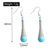 Turquoise stone earrings with silver wire design, shown with measurements on a white background.